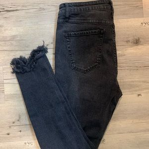 Distressed black skinny jeans